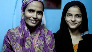 MDR-TB cured woman with her son at home in the Dharavi slum in Mumbai